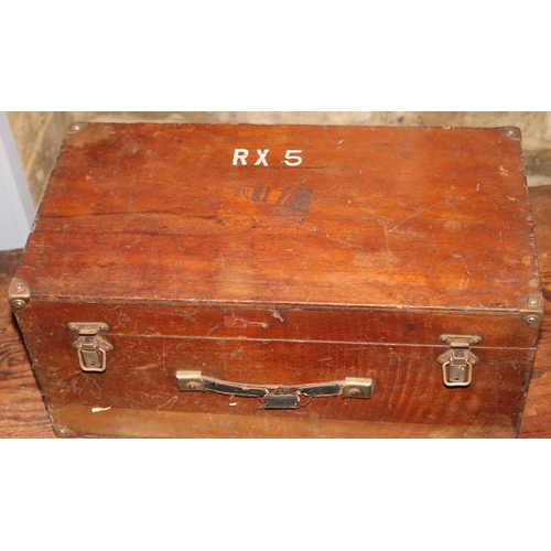 1053 - A wooden box with leather handle, metal corners and clips, RX5 painted to top, hinged lid, 49cm wide... 