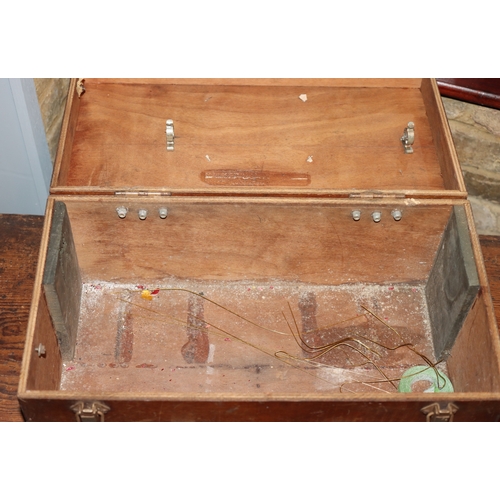 1053 - A wooden box with leather handle, metal corners and clips, RX5 painted to top, hinged lid, 49cm wide... 