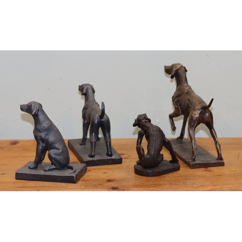 1056 - A group of dog figures, largest made of copper, 4 smaller bronze effect dogs.