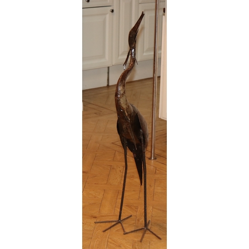 1058 - A metal heron ornament, 104cm high overall.