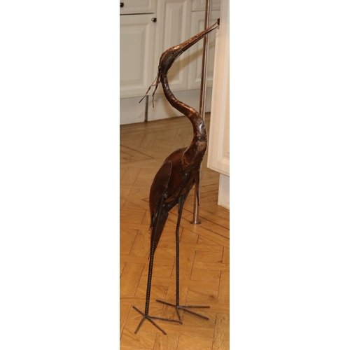 1058 - A metal heron ornament, 104cm high overall.