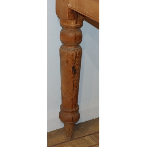 1059 - A pine kitchen table on turned legs, 151.5cm long, 119.3cm wide, 77cm high. This Lot is not held by ... 