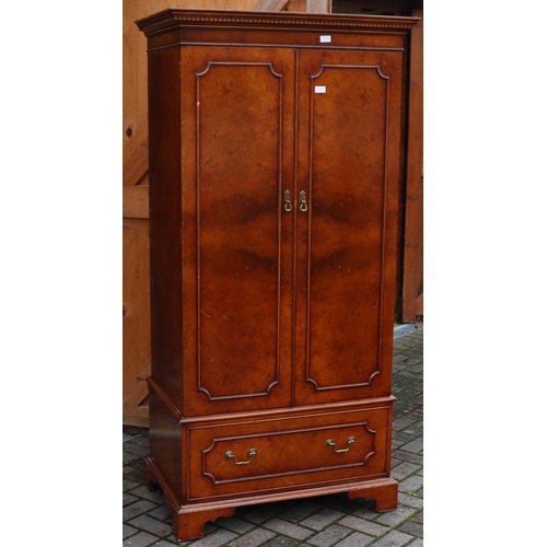 1104 - A good quality reproduction walnut double wardrobe with key pattern cornice, 2 panel doors enclosing... 