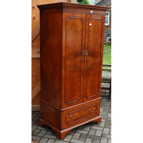 1104 - A good quality reproduction walnut double wardrobe with key pattern cornice, 2 panel doors enclosing... 