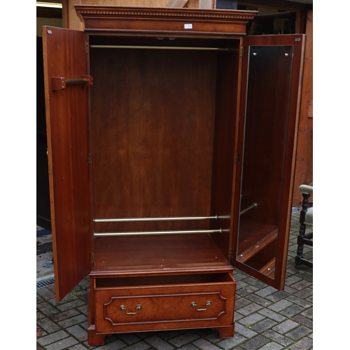 1104 - A good quality reproduction walnut double wardrobe with key pattern cornice, 2 panel doors enclosing... 