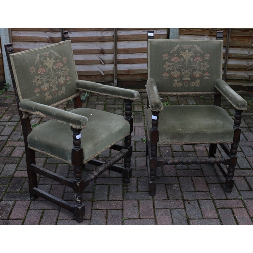 1107 - A pair of oak Cromwellian style carving chairs with green embroidered backs, padded arms and seats, ... 