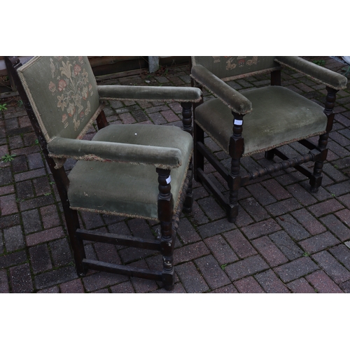 1107 - A pair of oak Cromwellian style carving chairs with green embroidered backs, padded arms and seats, ... 