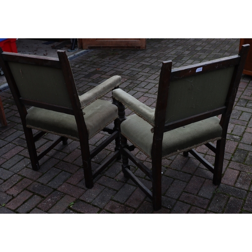 1107 - A pair of oak Cromwellian style carving chairs with green embroidered backs, padded arms and seats, ... 