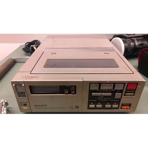 1116 - A Sony Trinicon Betamax video camera with portable video cassette recorder, additional lenses etc in... 