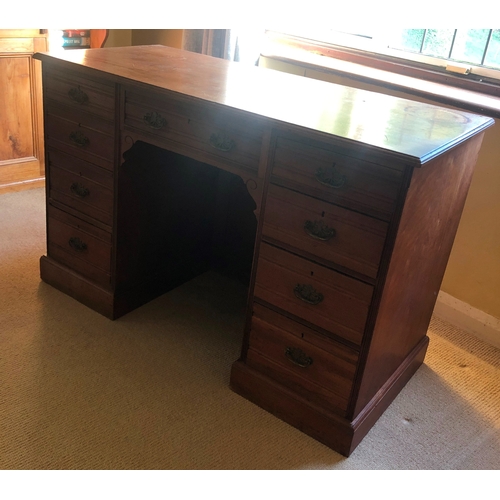 1152 - A walnut knee hole desk, central drawer flanked by 4 drawers either side, brass pull handles, 103.3c... 