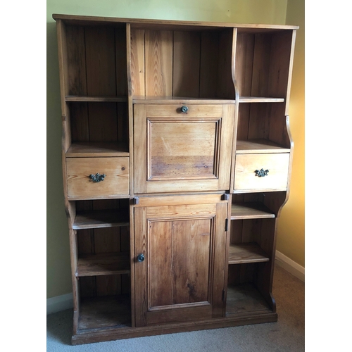 1153 - A pine shelved cupboard, 2 drawers, central writing slope enclosing pigeon holes and 2 small drawers... 