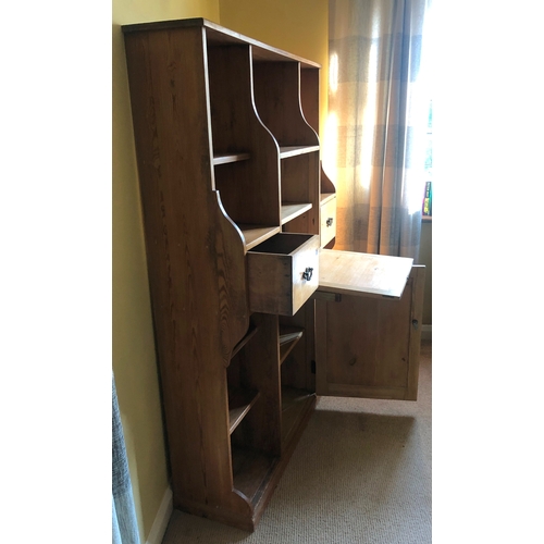 1153 - A pine shelved cupboard, 2 drawers, central writing slope enclosing pigeon holes and 2 small drawers... 