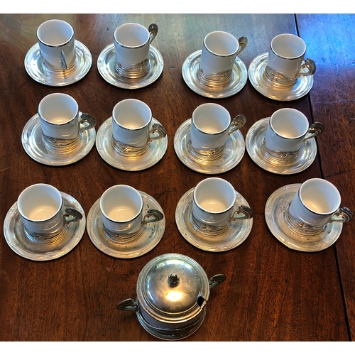 1176 - A set of 12 Italian white china and silver coloured coffee cups, 12 saucers and 1 sugar bowl with li... 