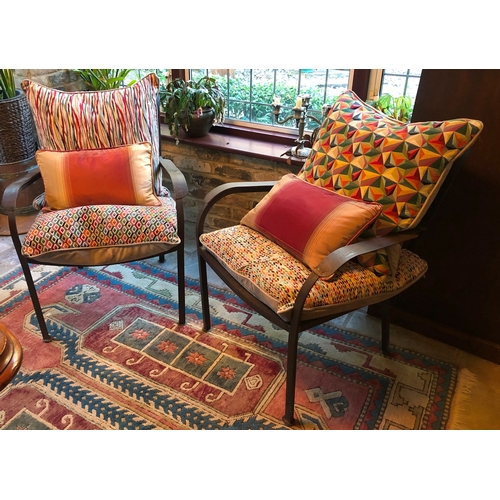 1181 - A pair of metallic chairs with multi-coloured cushions, 78cm high, 63.5cm wide. This Lot is not held... 