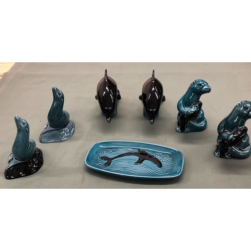 1222 - A quantity of Poole Pottery, 2 dolphins, 2 seals, 2 otters and a plate.