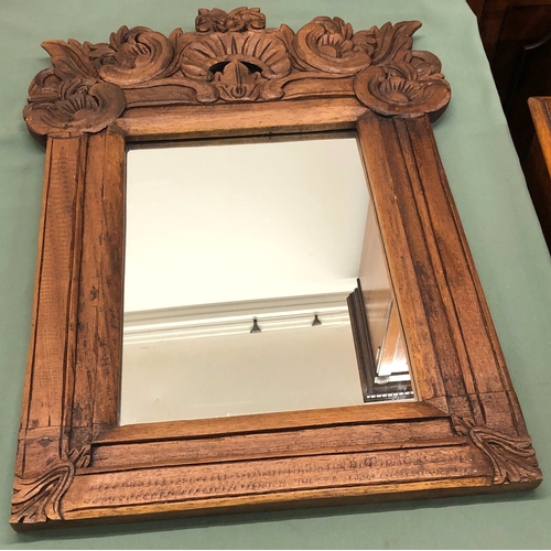 1228 - A mirror in carved wood frame, 55.5cm wide, 73cm high.