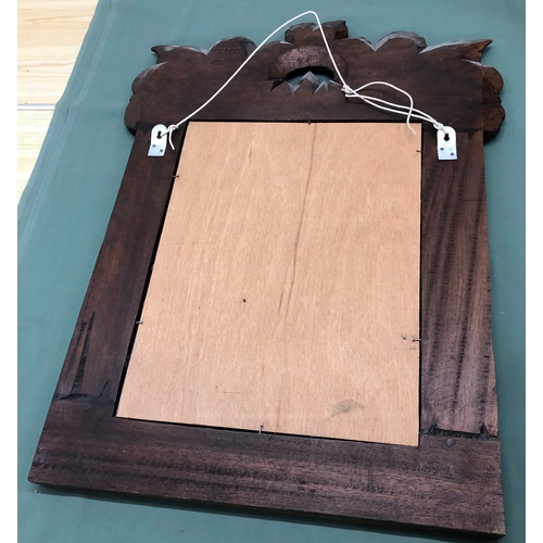 1228 - A mirror in carved wood frame, 55.5cm wide, 73cm high.