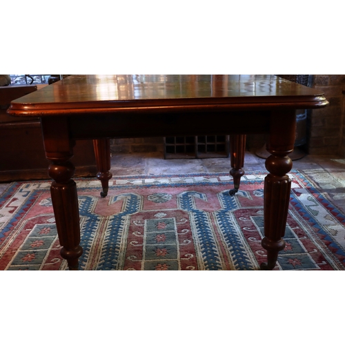 1275 - A Victorian mahogany dining table with 1 extra leaf, on turned legs and wheels, 108cm wide, 106cm de... 