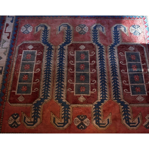 1276 - A square rug on red, blue and cream ground with tassels, 200 x 196cm.