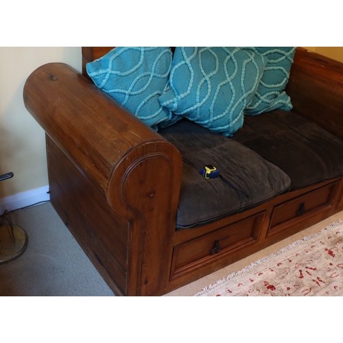 1280 - A heavy stained pine 2-seater bench with 2 drawers below, 2 dark brown suede style base cushions and... 