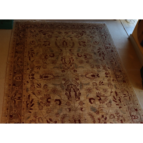 1281 - A dark cream and red rug with tassels, 274 x 182cm.