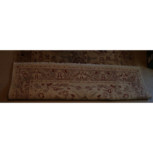 1281 - A dark cream and red rug with tassels, 274 x 182cm.