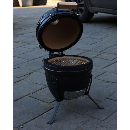 1286 - A small black egg style barbeque on metallic stand, matching hinged lid, ceramic interior with grill... 