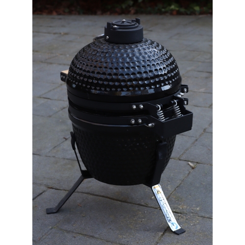 1286 - A small black egg style barbeque on metallic stand, matching hinged lid, ceramic interior with grill... 