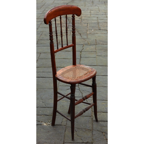 1290 - A tall child's chair with cane seat, 105cm high. This Lot is not held by PF Windibank. Please call t... 