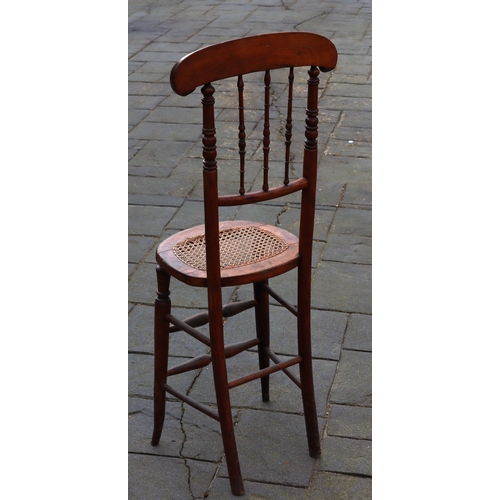 1290 - A tall child's chair with cane seat, 105cm high. This Lot is not held by PF Windibank. Please call t... 