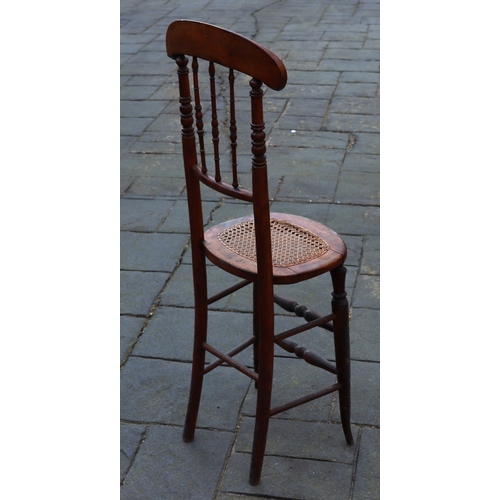 1290 - A tall child's chair with cane seat, 105cm high. This Lot is not held by PF Windibank. Please call t... 