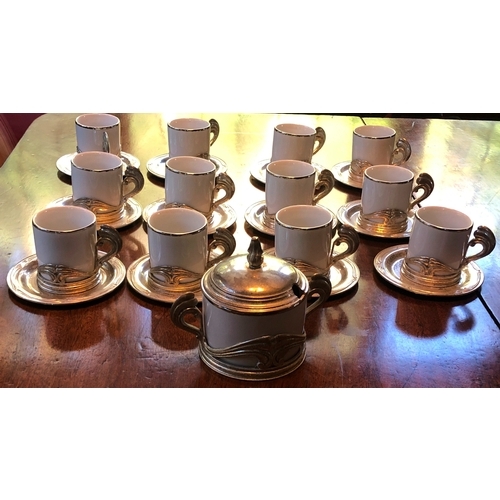 1176 - A set of 12 Italian white china and silver coloured coffee cups, 12 saucers and 1 sugar bowl with li... 