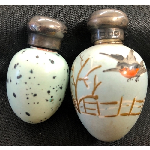 1220 - 2 miniature egg shaped painted scent bottles with silver screw lids.