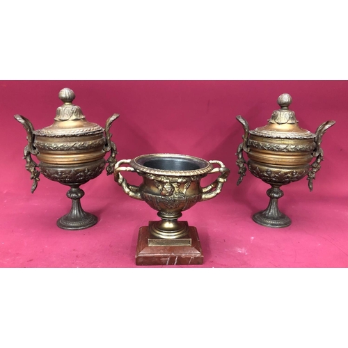 1240 - A pair of spelter lidded urns, 27cm high overall and a spelter censor, 16cm high. (3)