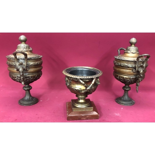 1240 - A pair of spelter lidded urns, 27cm high overall and a spelter censor, 16cm high. (3)