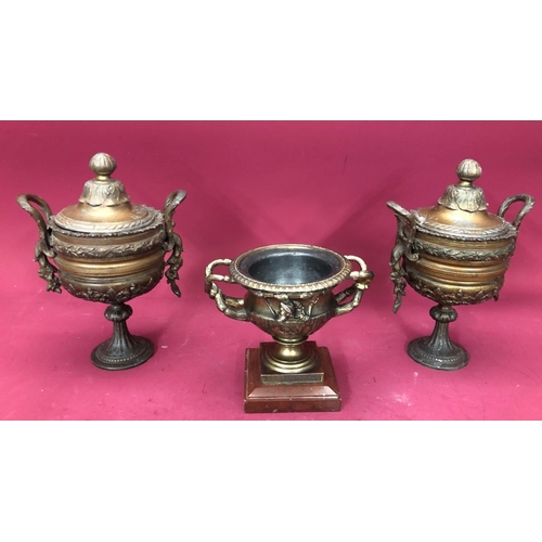 1240 - A pair of spelter lidded urns, 27cm high overall and a spelter censor, 16cm high. (3)