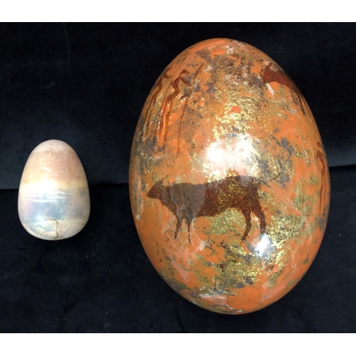 1247 - A painted ostrich egg and a stone egg with elephant decoration