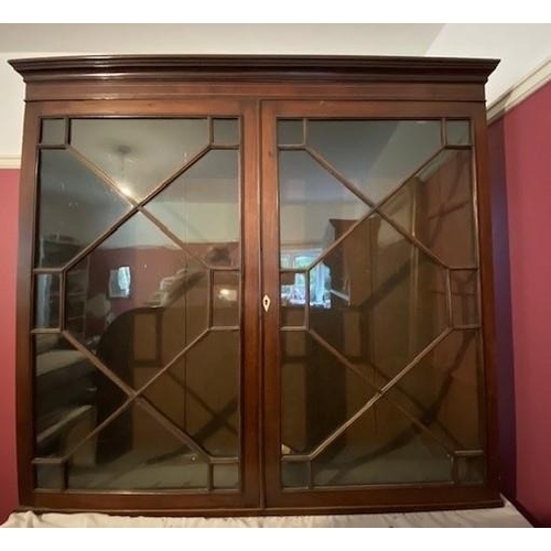 1262 - A reproduction mahogany cabinet with glass doors, 120cm wide, 30cm deep, 110cm high. This Lot is not... 