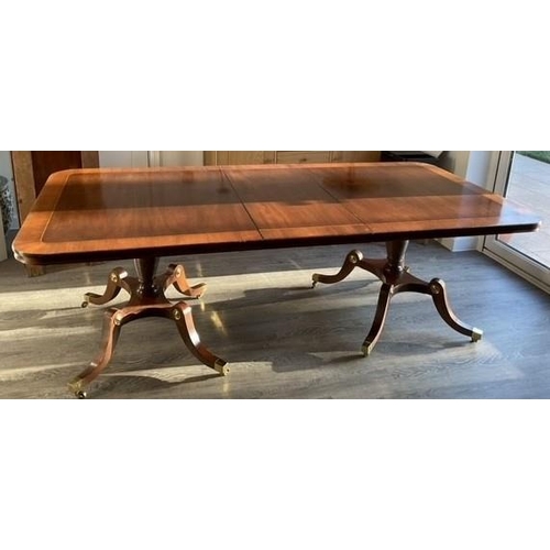 1300 - A reproduction mahogany extending, twin pedestal dining table with additional two leaves,  storage s... 