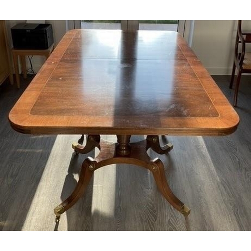 1300 - A reproduction mahogany extending, twin pedestal dining table with additional two leaves,  storage s... 