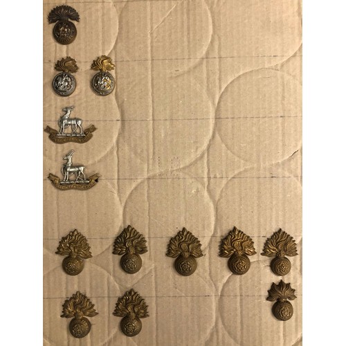 845 - A quantity of various military and other cap badges etc mounted on 10 boards