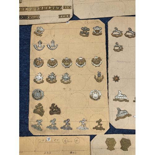 844 - A quantity of various military and other cap badges etc mounted on 10 boards