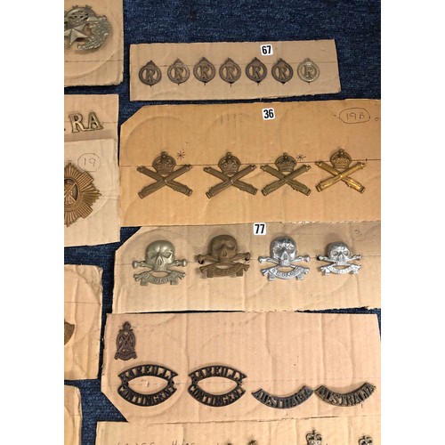 846 - A quantity of various military and other cap badges etc mounted on 26 cut down boards