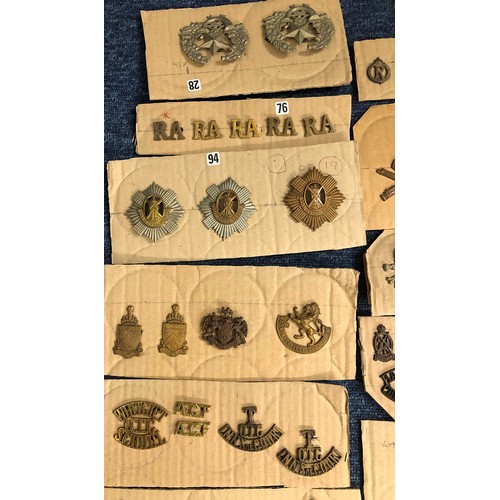 846 - A quantity of various military and other cap badges etc mounted on 26 cut down boards