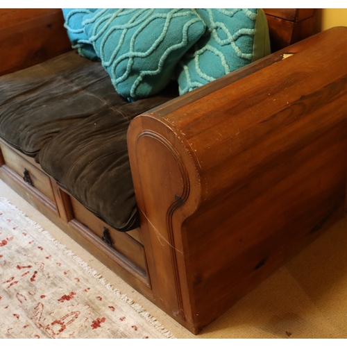 2302 - A stained pine 2-seater bench with 2 drawers below, with cushions and 2 turquoise scatter cushions, ... 