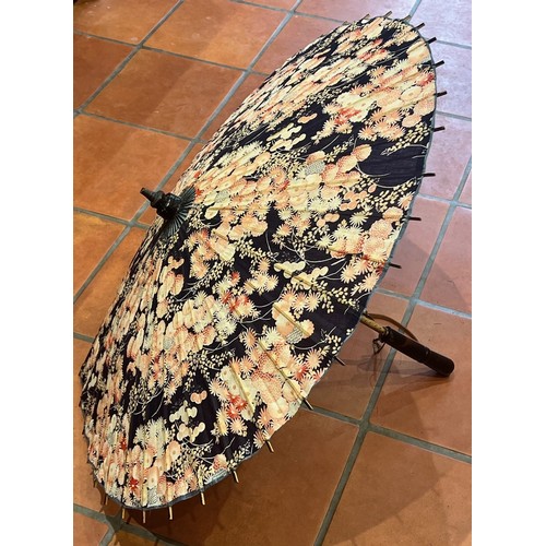 2303 - An Oriental bamboo and fabric parasol 63cm long