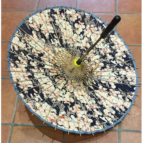 2303 - An Oriental bamboo and fabric parasol 63cm long