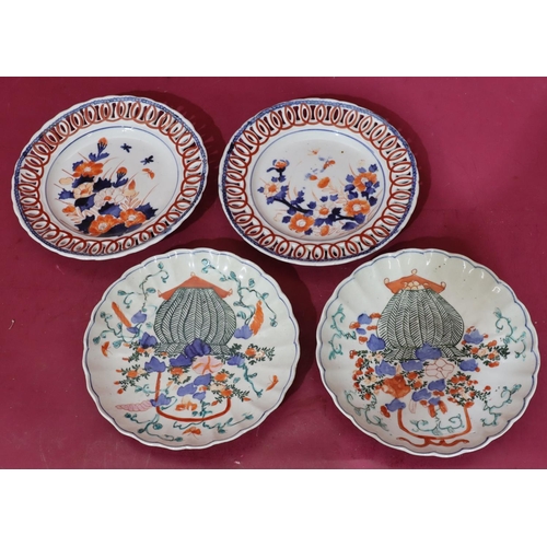 100 - A pair of Imari round ribbon plates on white, red and blue ground with butterfly, floral and leaf de... 