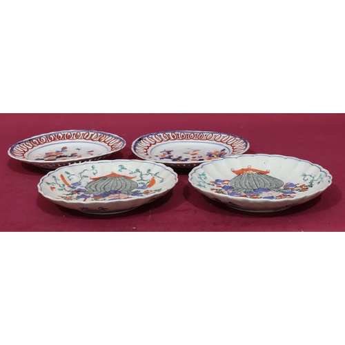 100 - A pair of Imari round ribbon plates on white, red and blue ground with butterfly, floral and leaf de... 