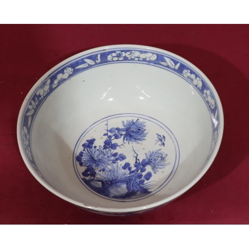 109 - An Oriental blue and white round trumpet shaped bowl with bird, branch, floral and leaf decoration, ... 